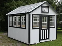 White portable office building with black trim, windows, and metal roof