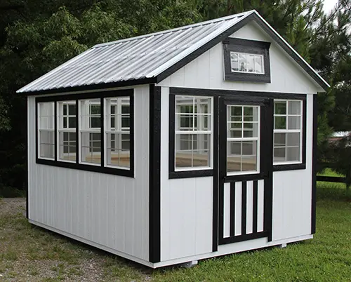 White portable office building with black trim, windows, and metal roof
